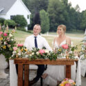 newly married couple sitting at head table