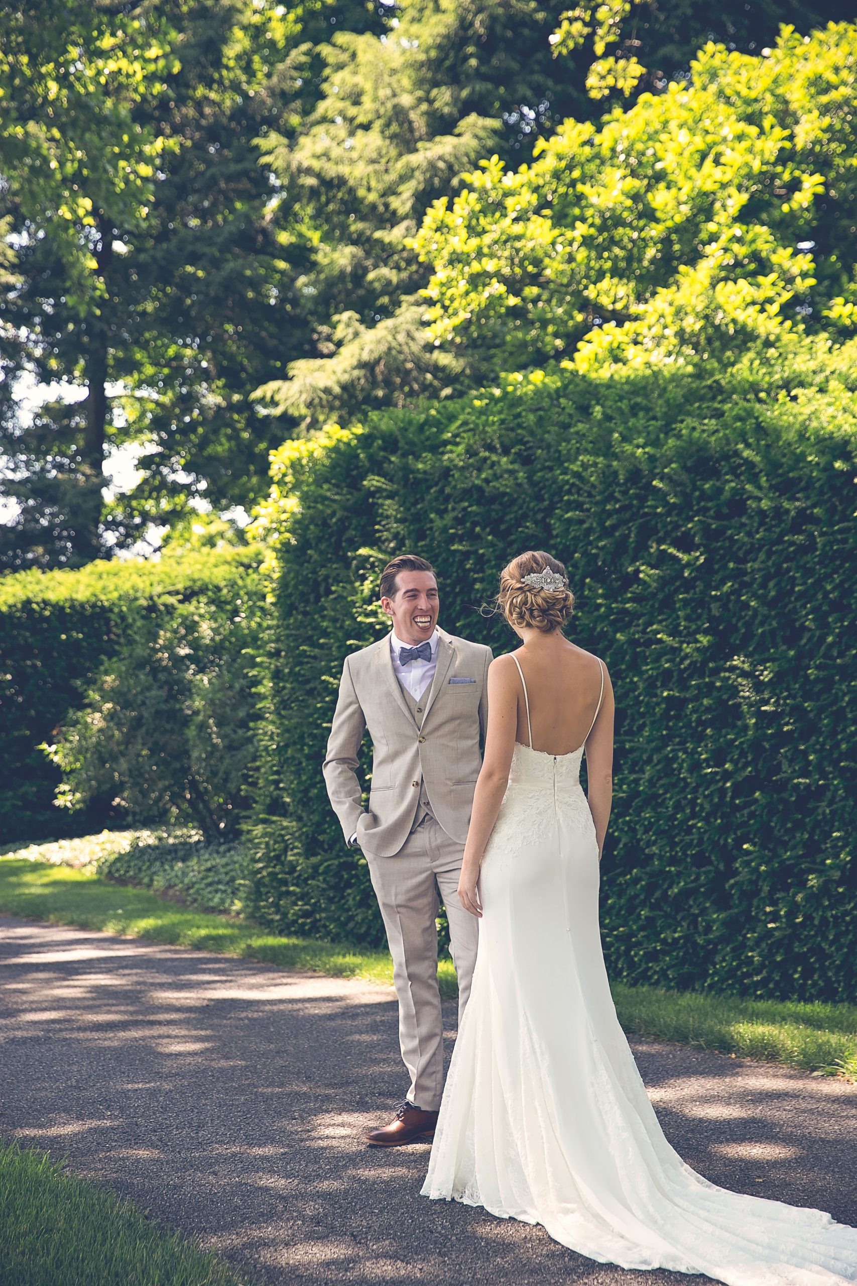 Bride and groom first look at each other on country lane