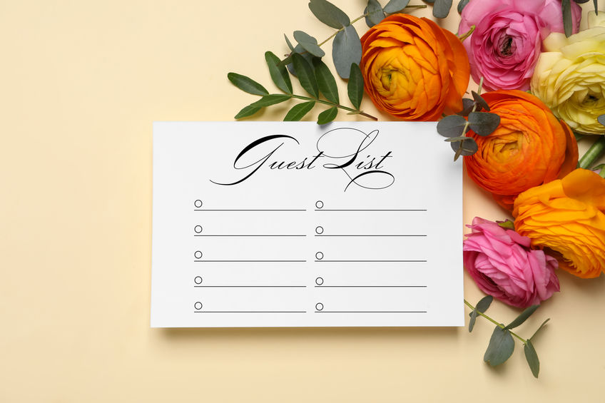 Beautiful flowers and guest list on beige background, flat lay