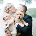 Bride & Groom with puppy kissing booth at the wedding