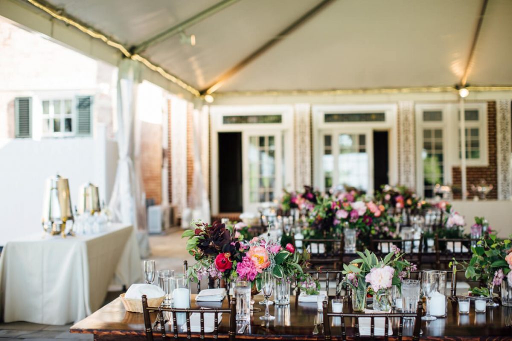 Wedding reception in The Grand Tent at Drumore Estate, farm tables, family style seating, pink florals
