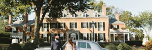 Bride and groom in front of vintage car at Drumore Estate mansion