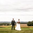 Bride and groom in front of fields