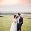 Bride and groom in countryside during sunset