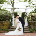 Bride and groom kissing in front of Drumore Estate
