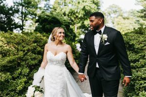 Bride and groom holding hands in Lancaster, PA outside in garden