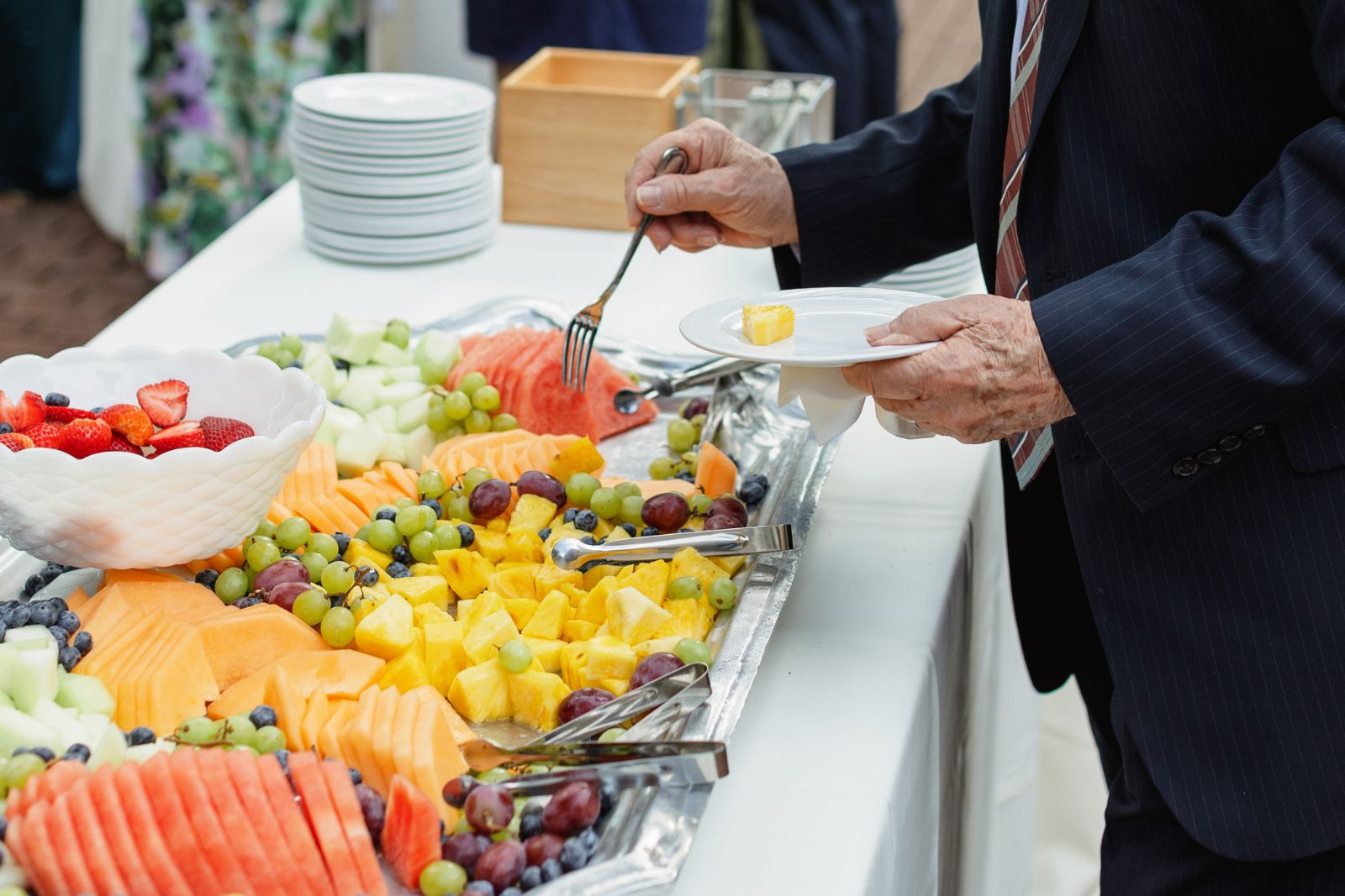 Person at buffet getting fruit in Lancaster, PA at Wedding Venue